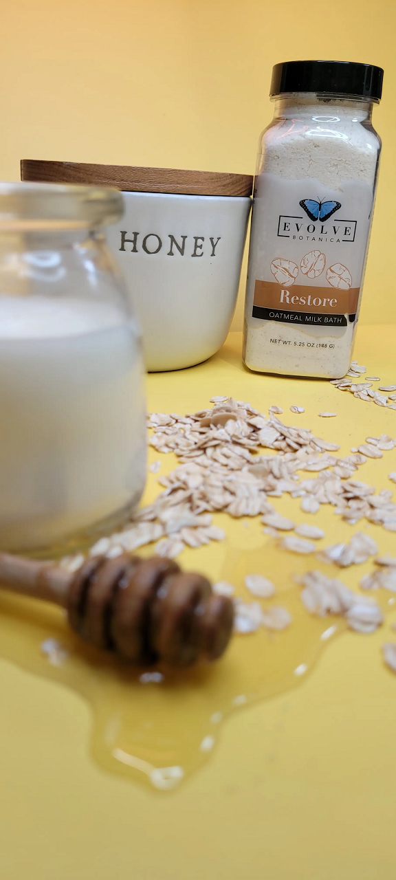 Evolve Botanica Milk Bath Restore with Oatmeal in a white jar, showcasing the soothing bath soak with natural ingredients.