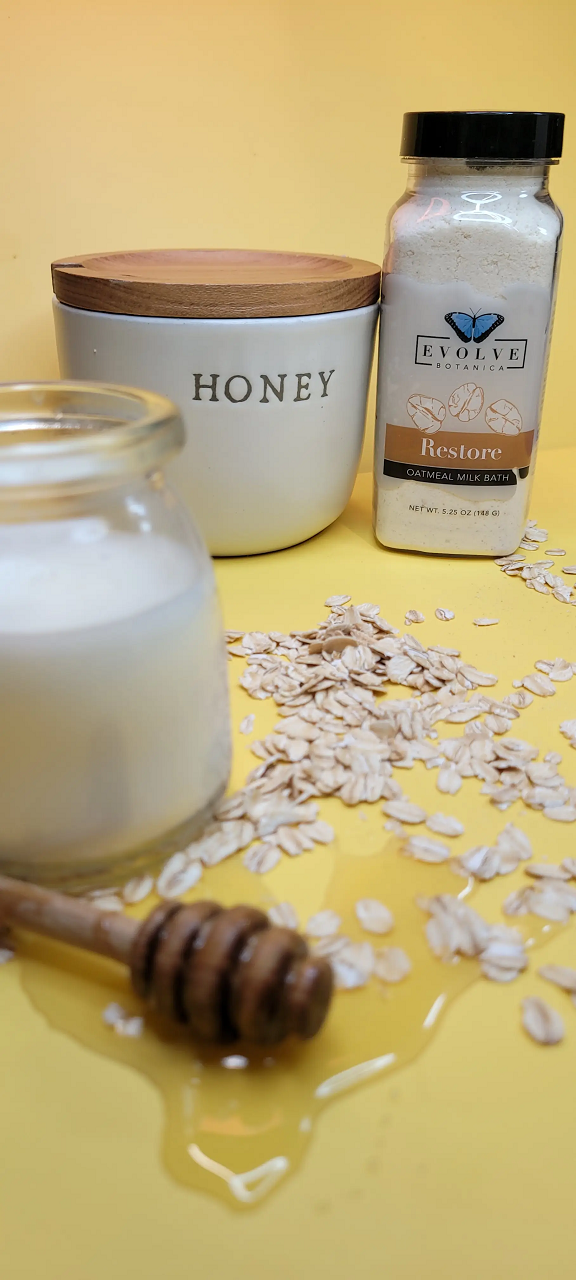 Evolve Botanica Milk Bath Restore with Oatmeal in a white jar, showcasing the nourishing oatmeal ingredients and relaxing bath product