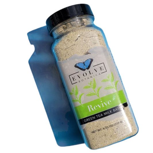Evolve Botanica Milk Bath Revive with Green Tea in a white jar, showcasing the nourishing bath product with green tea extracts.