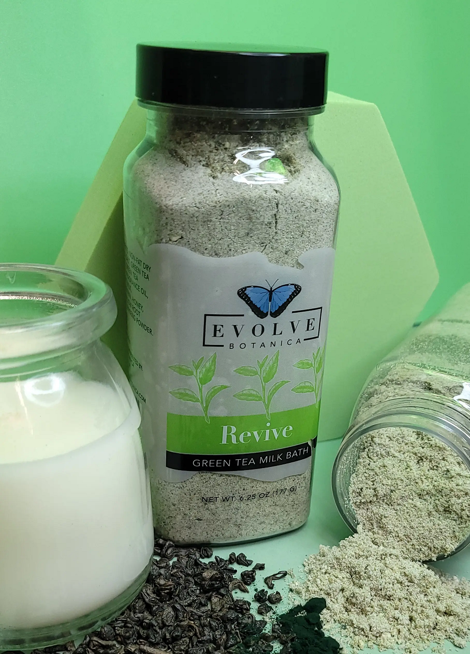 Evolve Botanica Milk Bath Revive with Green Tea in a jar, showcasing the soothing powdered bath product with green tea ingredients.