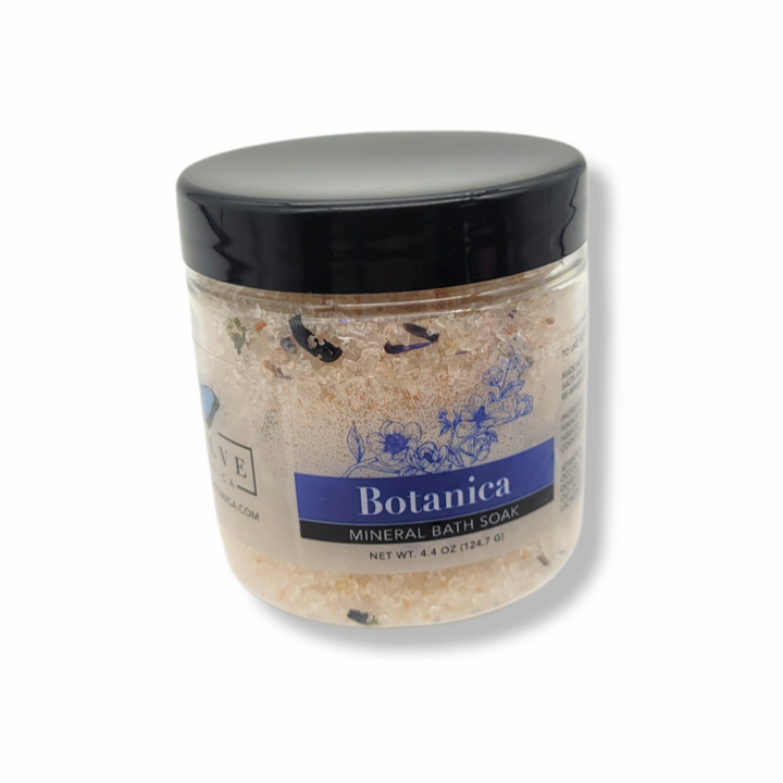 Mini Mineral Soak Bath Salt by Evolve Botanica in a clear container, showcasing natural mineral grains for relaxing bath rituals.