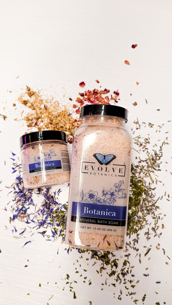 Mini Evolve Botanica Mineral Soak bath salt jar showing the label and textured salt crystals inside.