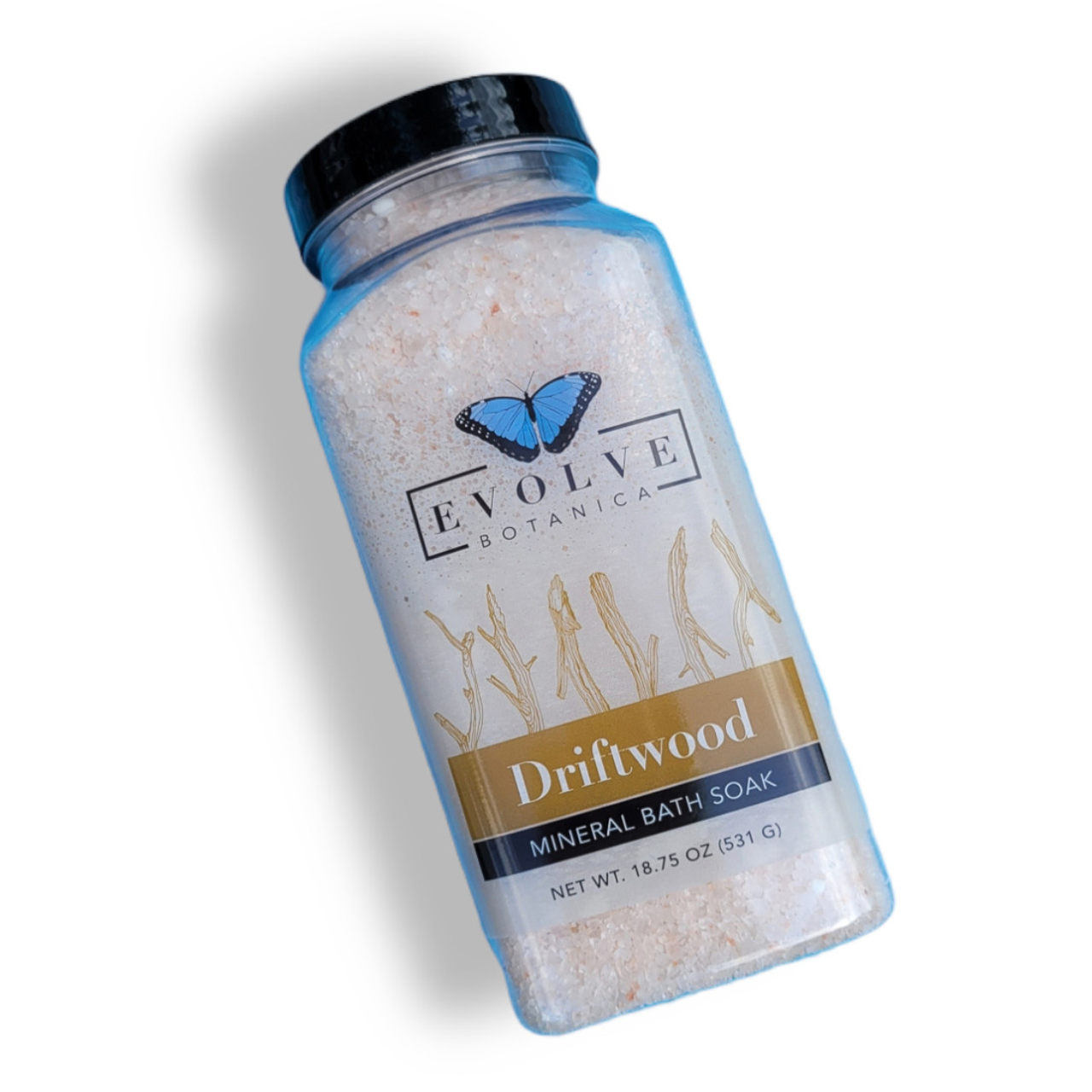 Evolve Botanica Mineral Soak Driftwood bath salt in a clear jar with driftwood and natural ingredients visible.