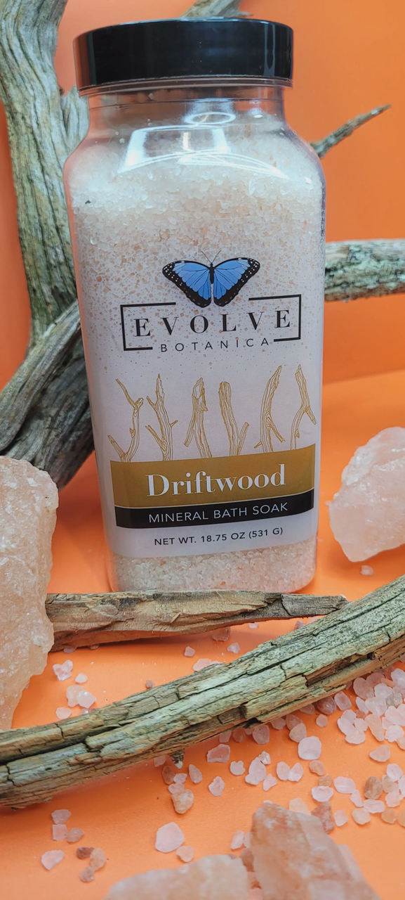 Evolve Botanica Mineral Soak Driftwood bath salt in a clear jar, showcasing natural mineral crystals ideal for relaxing baths.