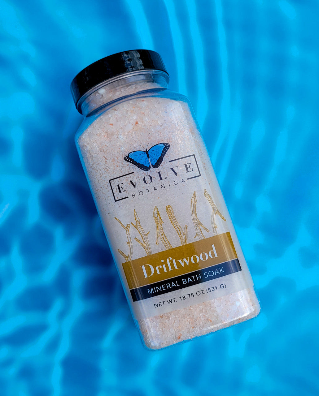 Evolve Botanica Mineral Soak Driftwood bath salt in a jar with natural driftwood scent and soothing mineral crystals.