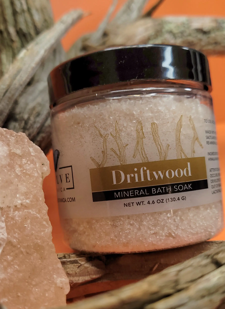 Mini Evolve Botanica Mineral Soak Driftwood bath salt in a clear jar with driftwood scent and natural mineral ingredients.