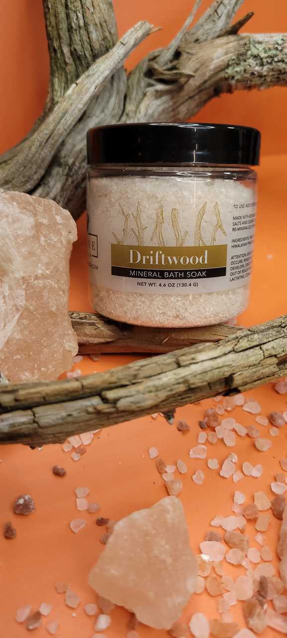 Mini bottle of Evolve Botanica Driftwood Mineral Soak bath salt, natural mineral bath product with driftwood scent.