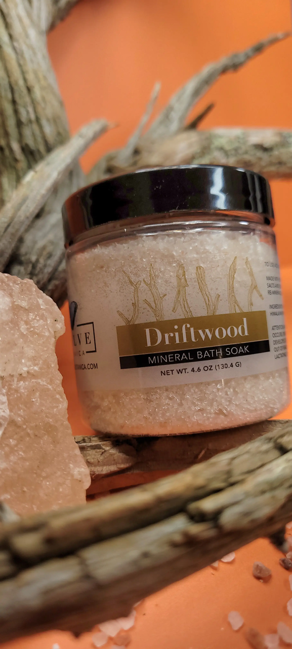 Mini Evolve Botanica Mineral Soak Driftwood bath salt in a clear jar with a natural driftwood scent and mineral crystals.