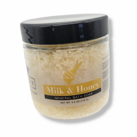 Mini bottle of Evolve Botanica Milk & Honey Mineral Soak bath salt, showing the label and packaging for relaxing bath rituals.