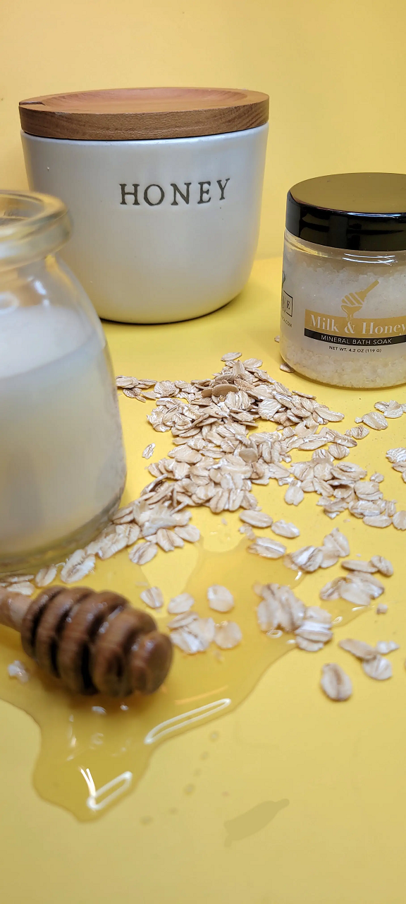 Mini bottle of Evolve Botanica Milk & Honey Mineral Soak bath salt with a clear label on a white background.