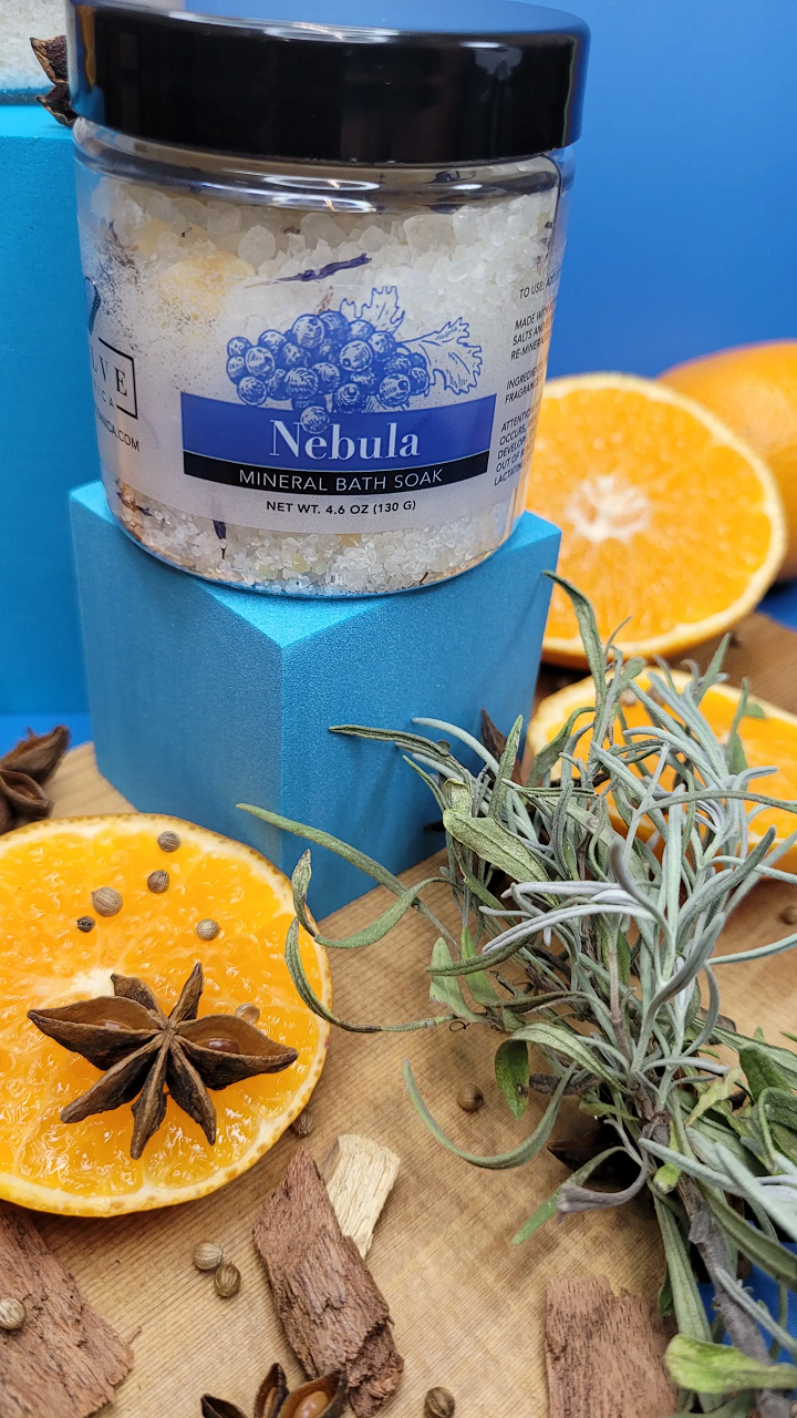 Mini Evolve Botanica Mineral Soak Nebula bath salt jar with colorful, textured bath salts inside.