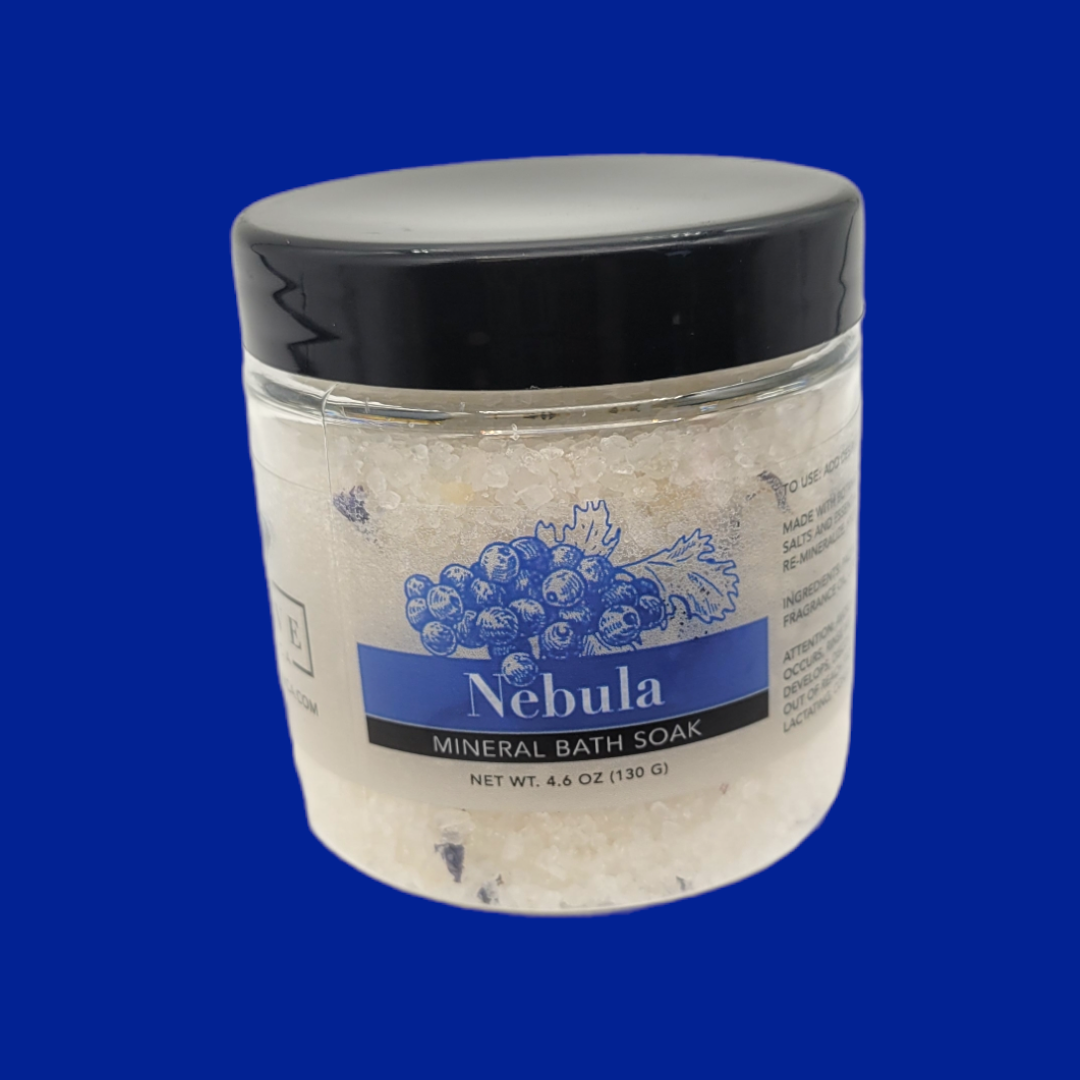 Mini Evolve Botanica Mineral Soak Nebula bath salt container with colorful label and natural ingredients visible.