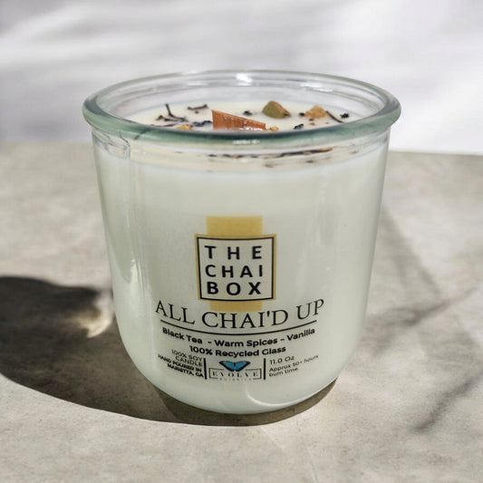 Evolve Botanica Rocks Candle Chai with wood wick and gemstone, soy wax, burning with warm, soothing glow.
