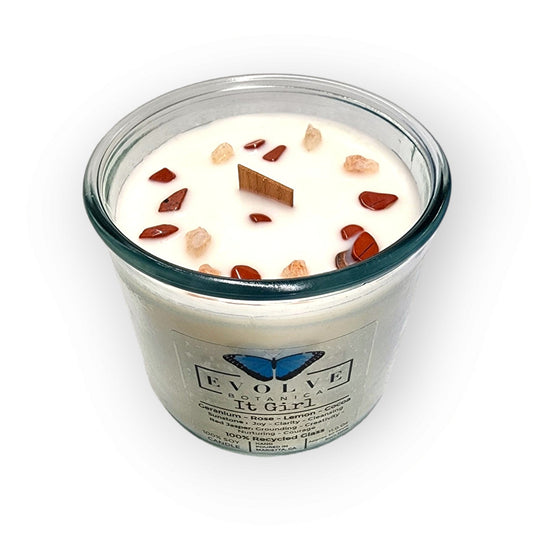 Evolve Botanica Rocks Candle It Girl with Sunstone and Red Jasper gemstones, soy wax, and wood wick for a cozy ambiance.