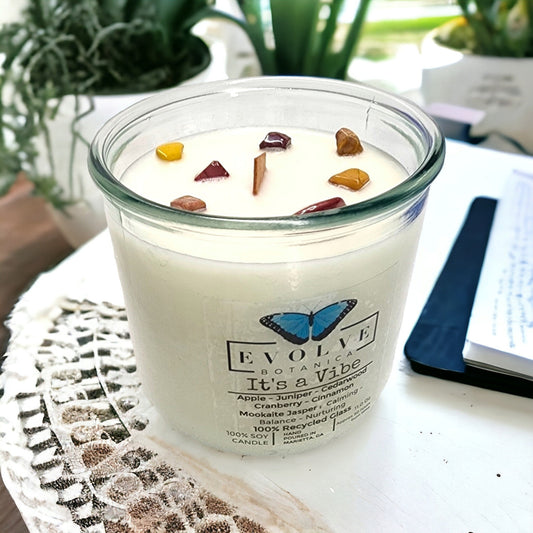 Evolve Botanica Rocks Candle It’s a Vibe with Mookite Jasper gemstone, wood wick, and soy wax, creating a calming, earthy ambiance.