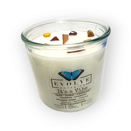 Evolve Botanica Rocks Candle It’s a Vibe with wood wick, Mookite Jasper gemstone, and soy wax in a stylish glass container.