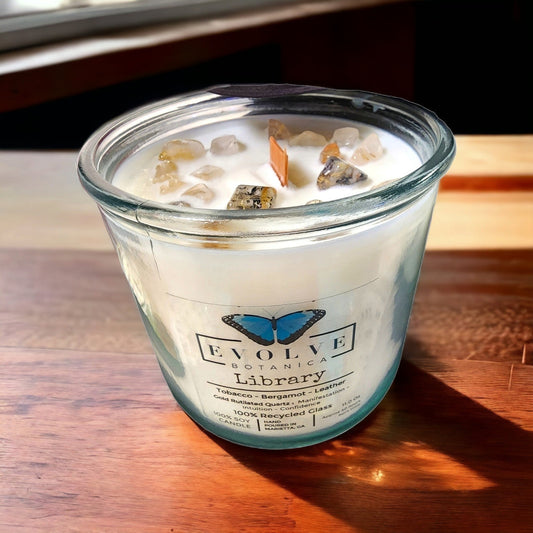 Evolve Botanica Rocks Candle Library soy candle with wood wick, gold rutilated quartz gemstone, in elegant glass container.