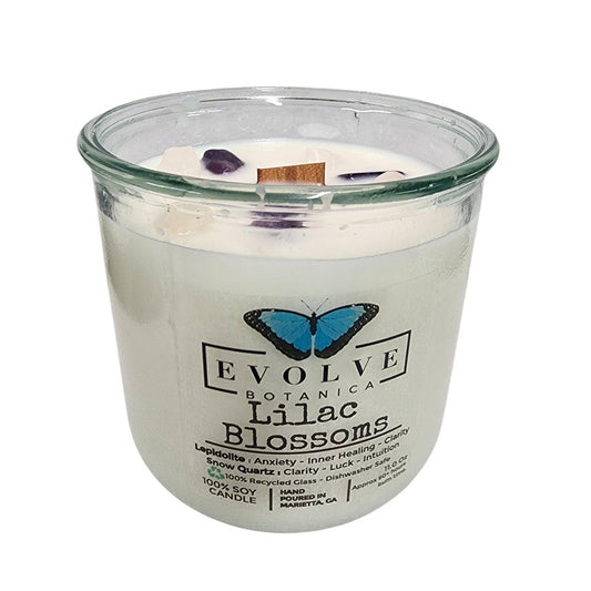 Lilac Blossoms Rocks Candle by Evolve Botanica with a wood wick, Lepidolite gemstone, and soy wax in a glass jar.