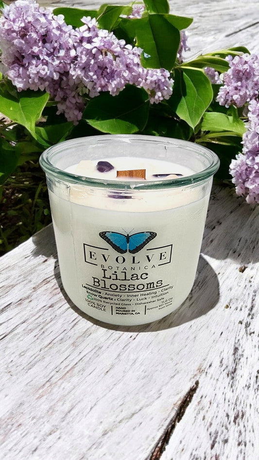 Evolve Botanica Rocks Candle Lilac Blossoms with wood wick and Lepidolite gemstone, soy wax candle in a glass container.