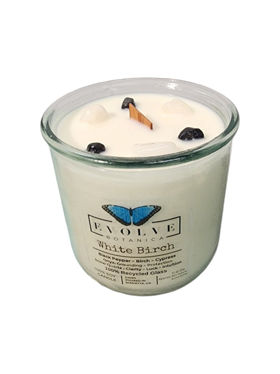 White Birch Rocks Candle by Evolve Botanica featuring a wood wick, snow quartz, onyx gemstones, and soy wax in a glass container.