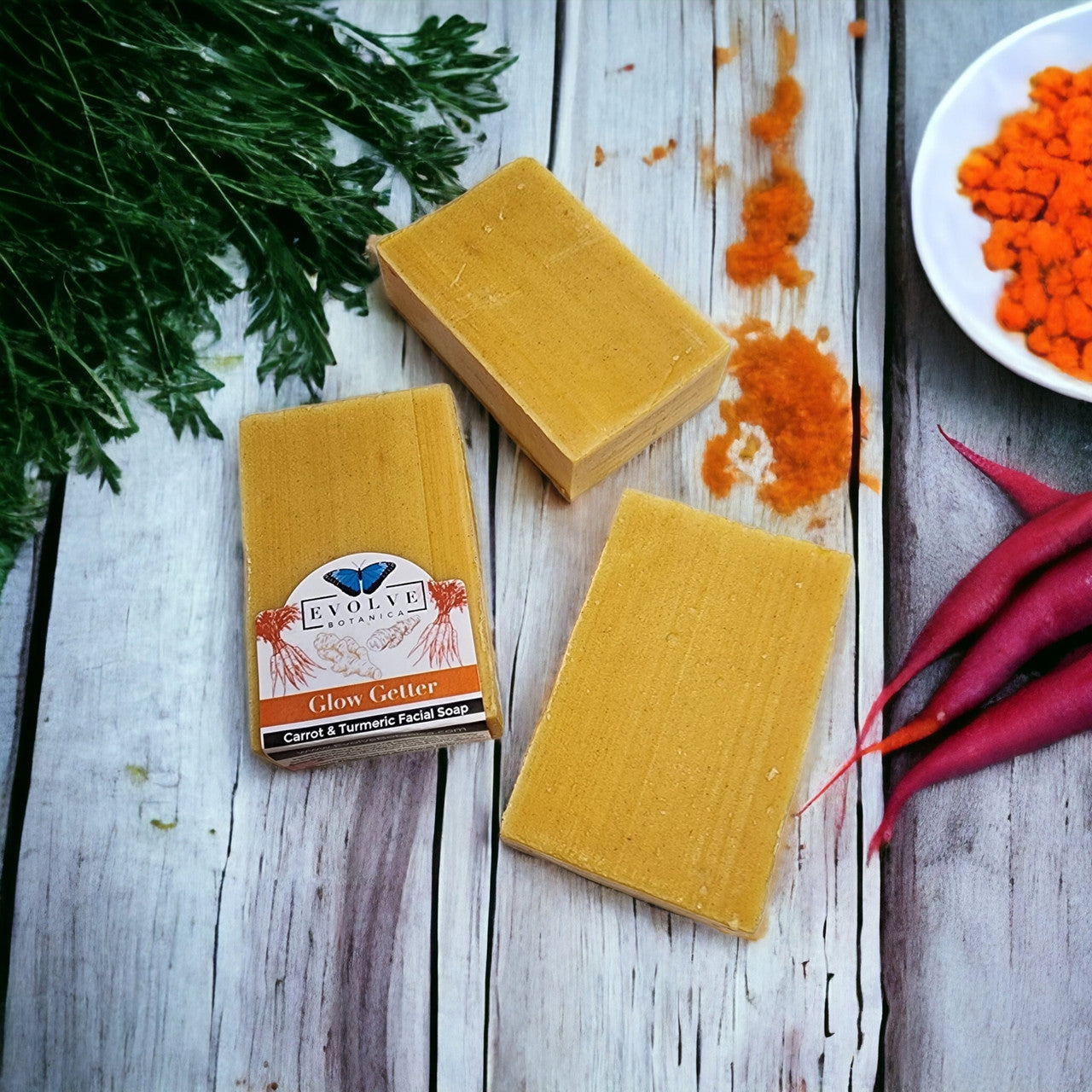 Evolve Botanica Glow Getter facial soap with carrot, turmeric, and honey, shown in a natural, eco-friendly packaging.