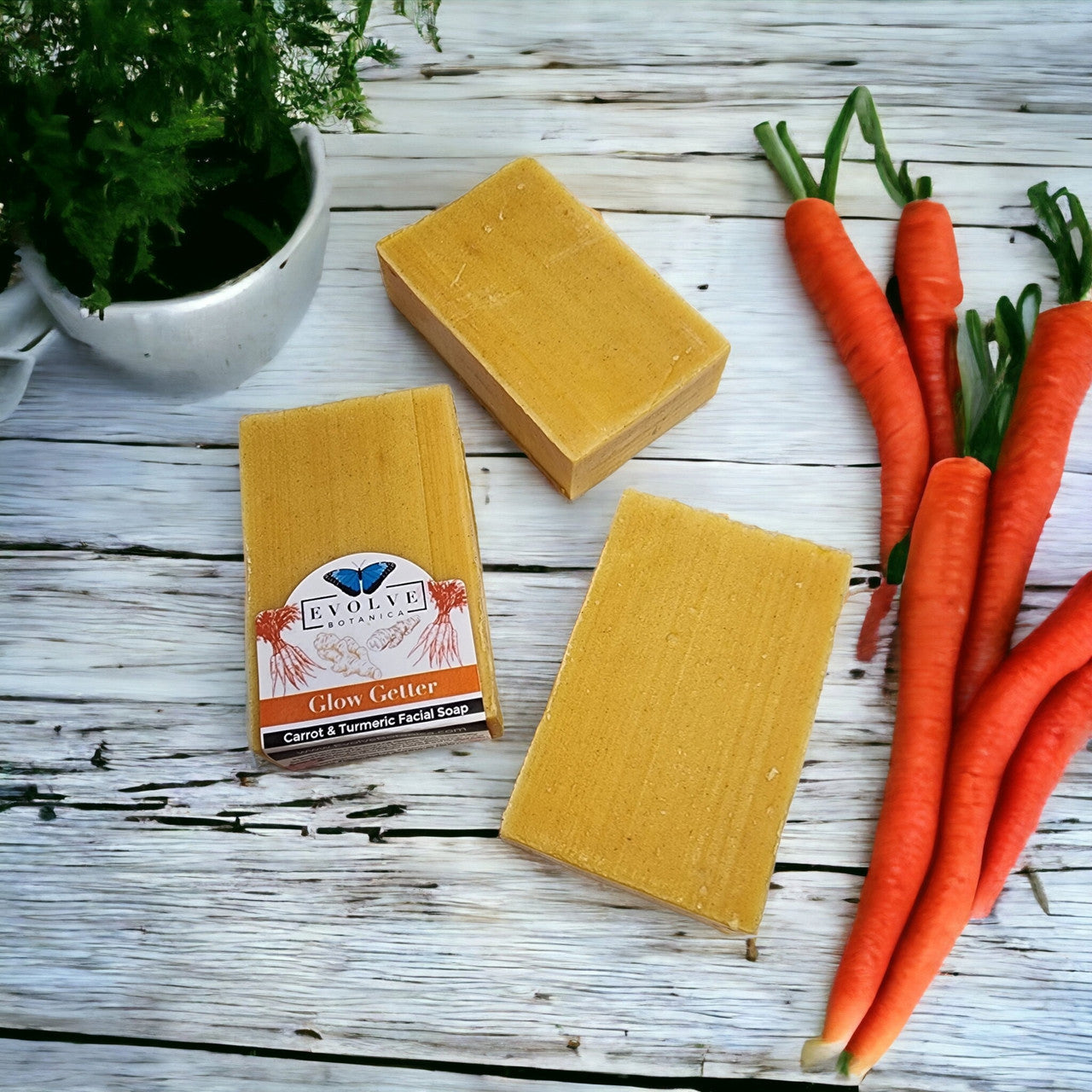 Evolve Botanica Glow Getter facial soap with carrot, turmeric, and honey for brightening and nourishing skin.