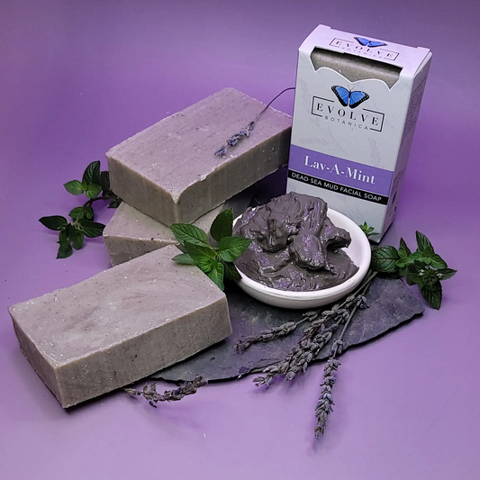 Evolve Botanica Lav-A-Mint Dead Sea Mud Facial Soap in a clear glassine bag, showing the soap's textured surface and minty color.