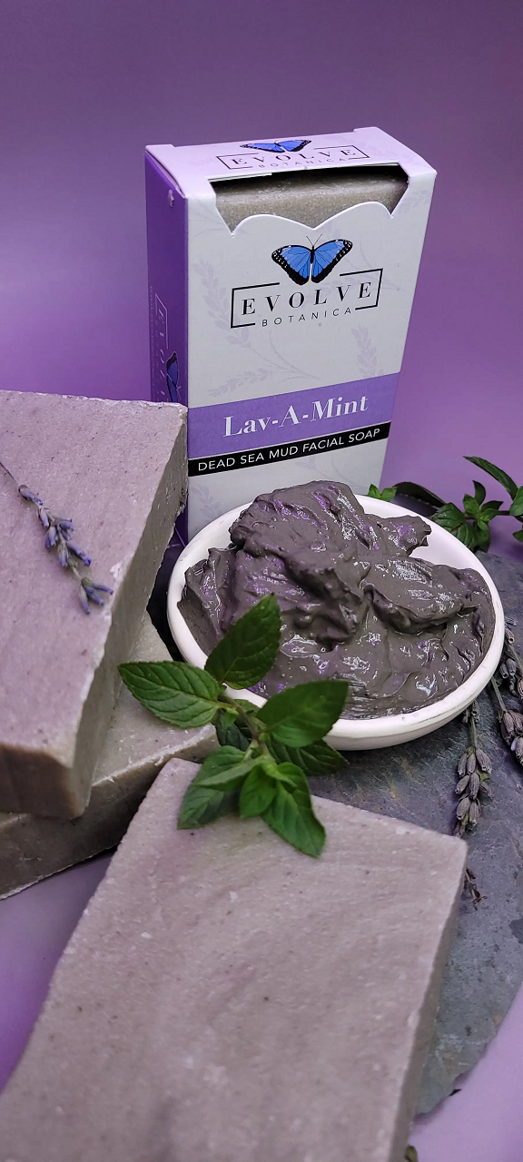 Evolve Botanica Lav-A-Mint Dead Sea Mud Facial Soap in a clear glassine bag, showcasing the natural soap bar with mint and mud ingredients.