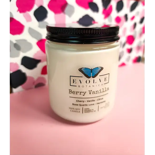 Classic 9oz Jam Jar soy candle by Evolve Botanica with berry vanilla scent, featuring a rose quartz crystal and natural wood wick.