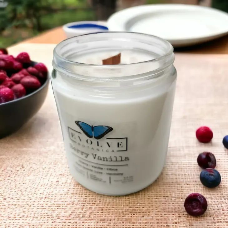 Classic 9oz Jam Jar soy candle by Evolve Botanica with Berry Vanilla scent, natural wood wick, rose quartz accents, and crystal details.