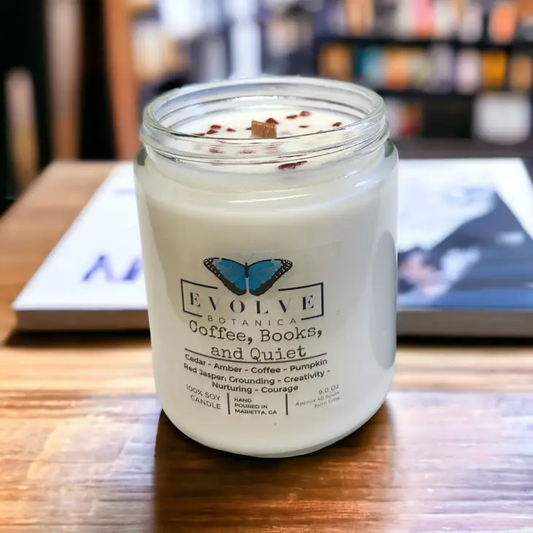 Evolve Botanica Classic 9oz Jam Jar Crystal Soy Candle with natural wood wick, featuring coffee, books, and quiet scene.