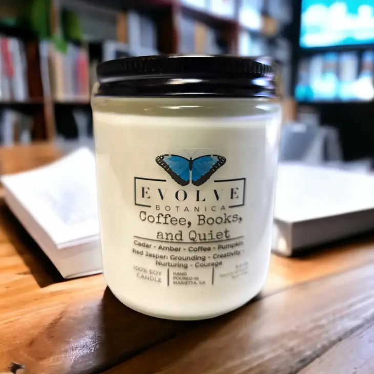 Evolve Botanica 9oz jam jar crystal soy candle with natural wood wick, labeled Coffee, Books, & Quiet, in Jasper.