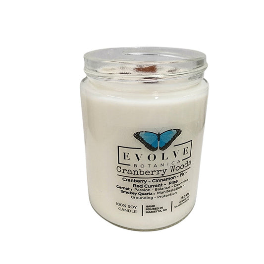 Evolve Botanica Classic 9oz Jam Jar Crystal Soy Candle with cranberry woods scent, garnet, and smokey quartz accents.