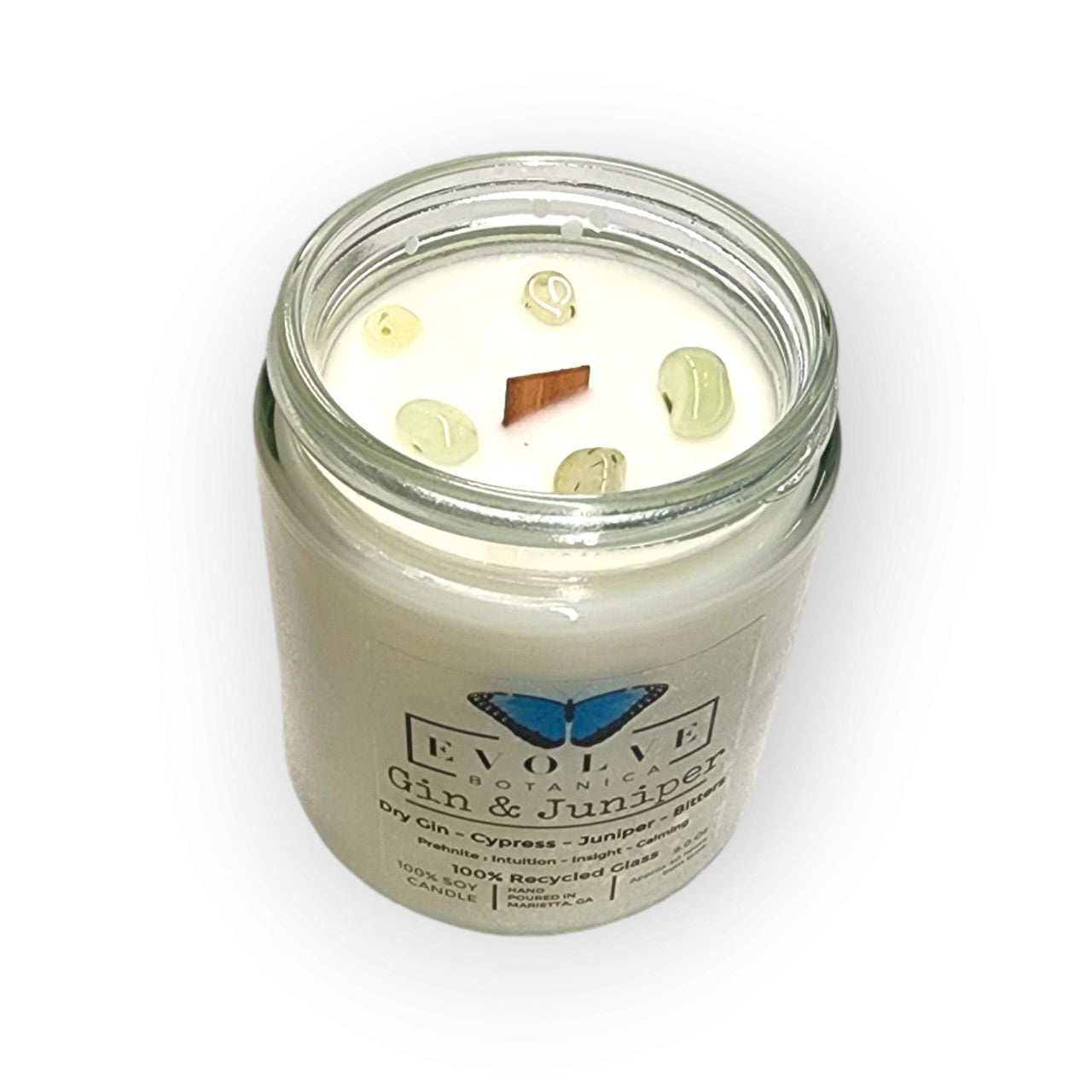 Evolve Botanica 9oz jam jar crystal soy candle with gin & juniper scent, natural wood wick, and prehnite crystal accents.