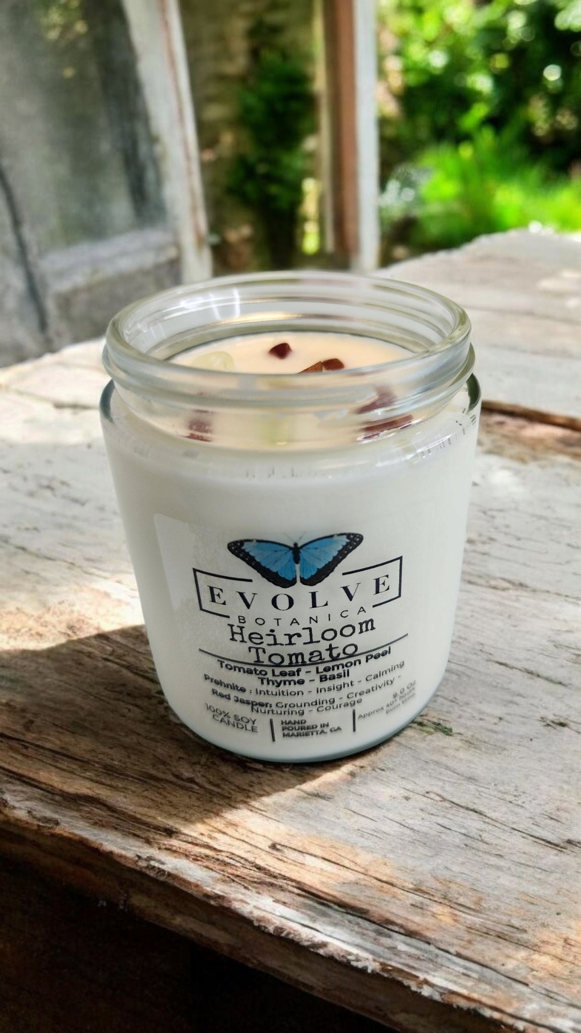 Evolve Botanica 9oz jam jar soy candle with heirloom tomato scent, crystal accents of prehnite and red jasper, natural wood wick
