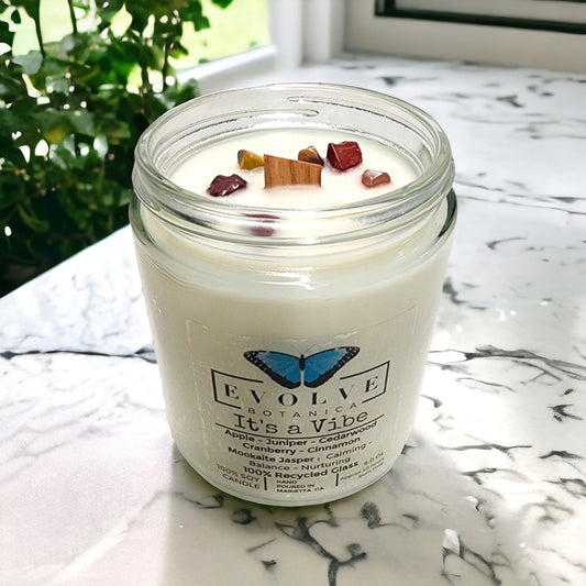 9oz jam jar soy candle with natural wood wick featuring Mookite Jasper crystal, from Evolve Botanica, creating a calming vibe.