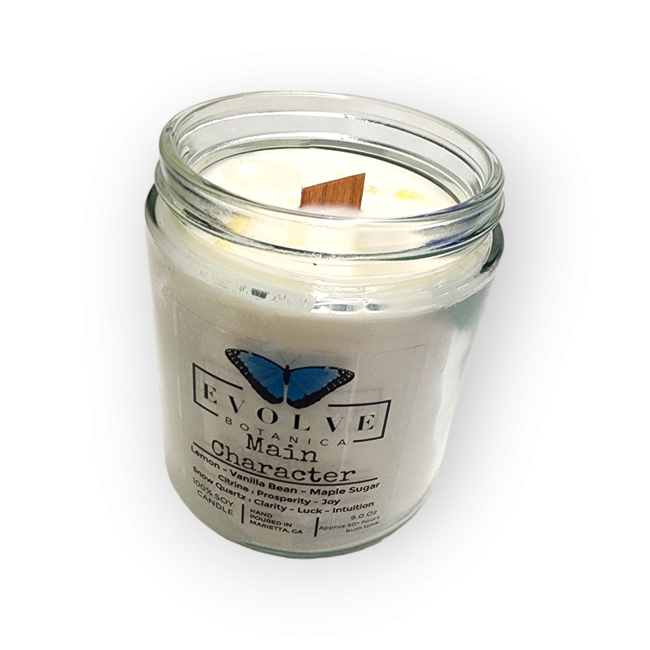 Evolve Botanica 9oz jam jar soy candle with natural wood wick, featuring citrine and snow quartz crystals for a calming ambiance.