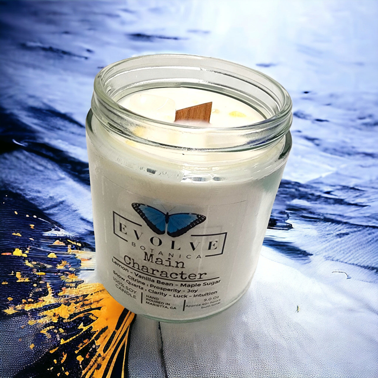 Evolve Botanica 9oz jam jar crystal soy candle with citrine and snow quartz, natural wood wick, showcasing the main character design.