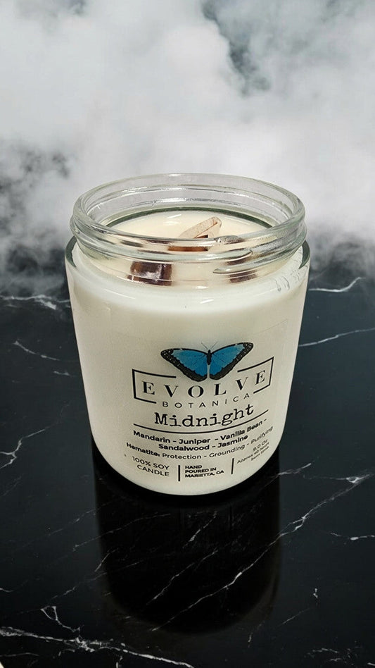 Evolve Botanica Midnight 9oz Jam Jar Crystal Soy Candle with natural wood wick, featuring a dark, elegant appearance.