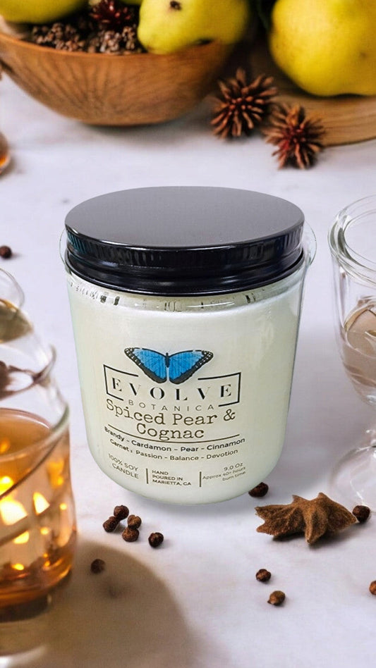 Evolve Botanica classic 9oz jam jar crystal soy candle with natural wood wick, Spiced Pear & Cognac scent, Garnet color.