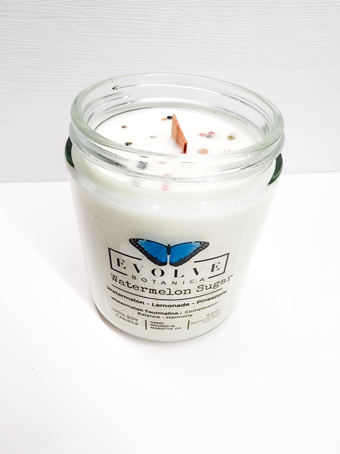 Evolve Botanica 9oz jam jar soy candle with water watermelon sugar scent, natural wood wick, crystal accents, and colorful watermelon tourmaline.