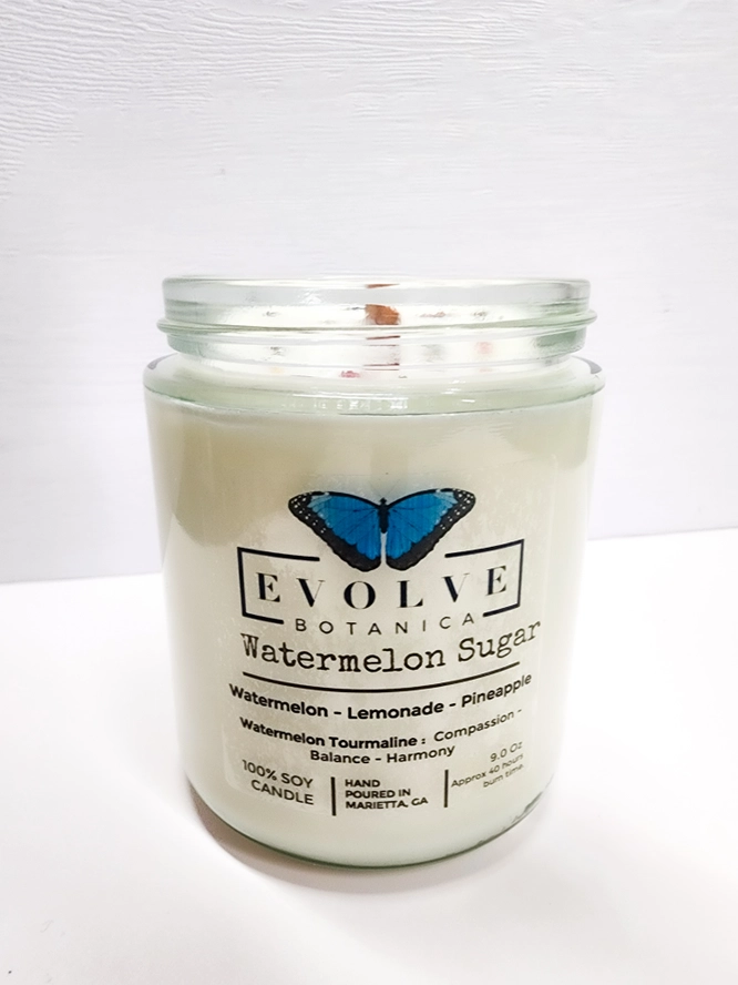 Classic 9oz Jam Jar soy candle by Evolve Botanica with a natural wood wick, Watermelon Sugar scent, and Watermelon Tourmaline crystal.