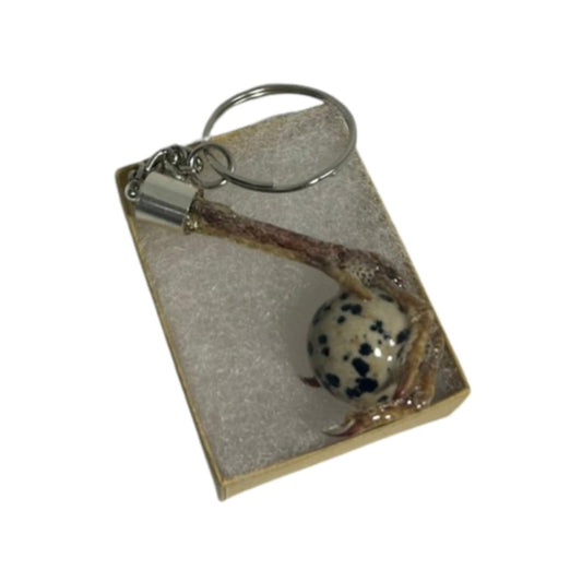 Quailz.com Quail Foot Keychain with faux quail egg stone, detailed miniature bird foot and decorative egg-shaped stone.