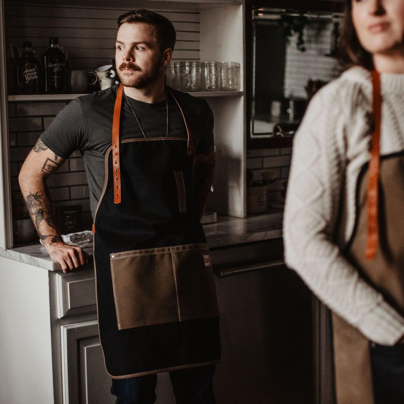 Waxed canvas apron by The Local Branch, USA-made, featuring durable waxed fabric and adjustable straps, ideal for crafts and cooking.