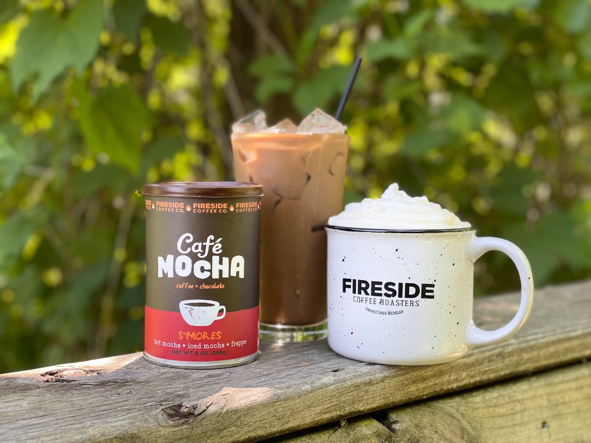 Fireside Coffee Co. S'mores Cafe Mocha in a mug with whipped cream, chocolate drizzle, and graham cracker crumbs on top.