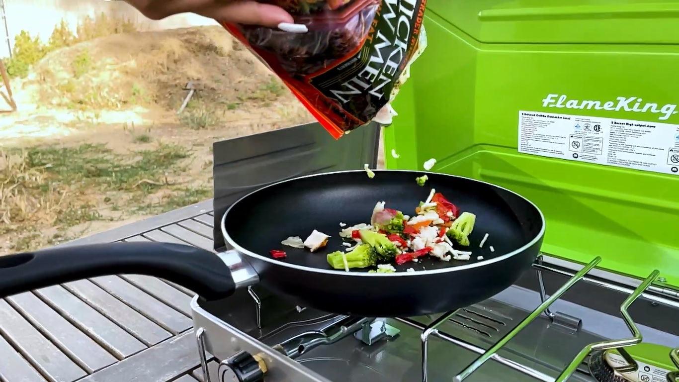 Flame King portable propane camping stove with two burners, compact design, ideal for outdoor cooking and camping trips.