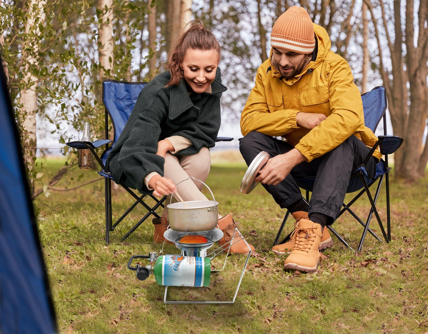 Portable Flame King burner cooker heater for camping, featuring a compact design with a sturdy metal frame and adjustable control knob.