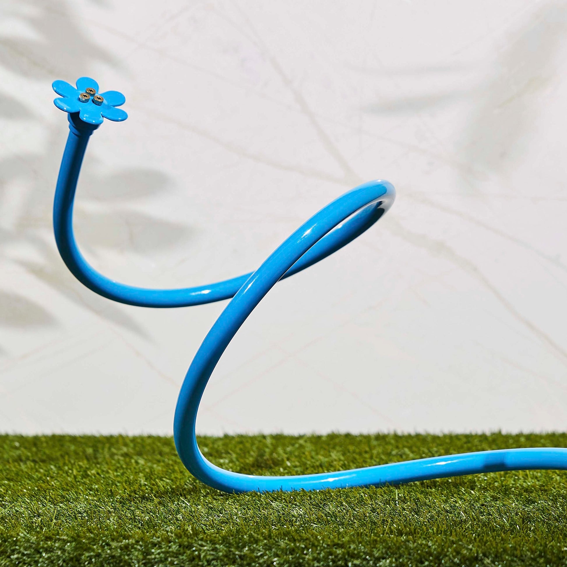 Orbit Irrigation Cobra Mist System with flexible stand and mist nozzle for personal cooling, shown in a garden setting.