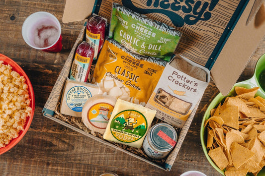 Cheese Brothers Deluxe Game Day Essentials Gift Pack with snacks, drinks, and game day accessories in a colorful bundled set.