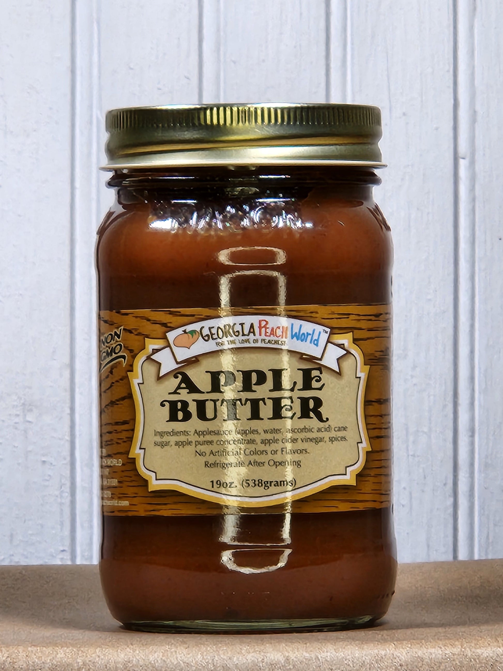 Creamy apple butter from Georgia Peach World in a jar, perfect for spreading on toast or using in recipes.